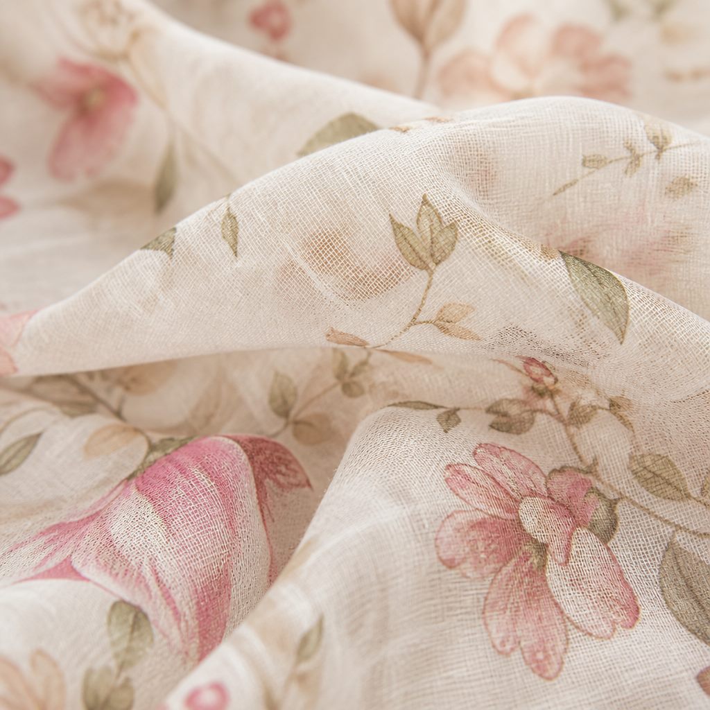 Macro texture of lightweight printed lawn fabric in blush and ivory